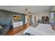 Spacious main bedroom with hardwood floors, ceiling fan, TV, and a seating area for relaxation and entertainment at 3880 Pinstar Ter, North Port, FL 34287