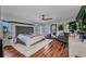Spacious main bedroom with hardwood floors, a tufted headboard, and ample natural light from multiple windows at 3880 Pinstar Ter, North Port, FL 34287