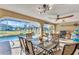 This is a screened patio with a dining table and a view of the pool at 3880 Pinstar Ter, North Port, FL 34287