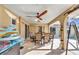 This covered patio features a dining table and ceiling fans, perfect for outdoor entertaining at 3880 Pinstar Ter, North Port, FL 34287