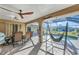 This patio features a dining table, ceiling fans, and a hanging chair near the pool at 3880 Pinstar Ter, North Port, FL 34287