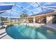 Relaxing screened-in pool with clear water, solar panels, and outdoor seating at 3880 Pinstar Ter, North Port, FL 34287