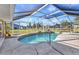 This enclosed pool features a handrail, outdoor lighting, and surrounding homes at 3880 Pinstar Ter, North Port, FL 34287