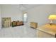 Spacious bedroom with white tile floors and light wood furniture at 412 Panarea Dr, Punta Gorda, FL 33950