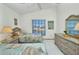 Charming bedroom featuring two twin beds, waterfront view, and wicker furniture at 412 Panarea Dr, Punta Gorda, FL 33950