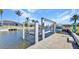 Canal-front home featuring a private dock with boat lift, perfect for boating enthusiasts at 412 Panarea Dr, Punta Gorda, FL 33950