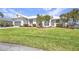Beautiful home featuring lush lawn, meticulous landscaping, and a well-maintained exterior at 412 Panarea Dr, Punta Gorda, FL 33950