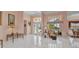 Bright foyer with beautiful chandelier, glass double-doors, and large-format tile flooring at 412 Panarea Dr, Punta Gorda, FL 33950