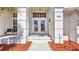 Elegant entryway with decorative glass doors and tiled walkway lined with mulch at 412 Panarea Dr, Punta Gorda, FL 33950