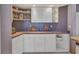Kitchen featuring a breakfast nook, cabinets, and white tile flooring at 412 Panarea Dr, Punta Gorda, FL 33950