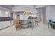 Open kitchen featuring white cabinets, white tile flooring, and a breakfast bar with seating at 412 Panarea Dr, Punta Gorda, FL 33950