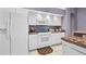 Kitchen featuring white appliances and a breakfast bar with seating at 412 Panarea Dr, Punta Gorda, FL 33950