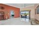 Spacious living area with tile flooring, large windows, and access to the outdoor patio at 412 Panarea Dr, Punta Gorda, FL 33950