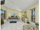 Bright main bedroom featuring tile floors, a four-poster bed, and water views at 412 Panarea Dr, Punta Gorda, FL 33950