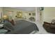 Comfortable main bedroom featuring a four-poster bed, tiled floors, and soft lighting at 412 Panarea Dr, Punta Gorda, FL 33950