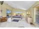 Bright main bedroom featuring tile floors, a four-poster bed, and water views at 412 Panarea Dr, Punta Gorda, FL 33950
