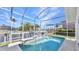 Inviting backyard pool area with screened-in patio and waterfront view at 412 Panarea Dr, Punta Gorda, FL 33950