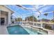Beautiful pool and lanai overlooking a canal with a dock and boat lift at 412 Panarea Dr, Punta Gorda, FL 33950