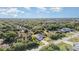 Drone shot of the home, surrounded by greenery and other houses at 422 Ravenswood Blvd, Port Charlotte, FL 33954