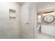 Shower in updated bathroom with niche; vanity is adjacent at 422 Ravenswood Blvd, Port Charlotte, FL 33954