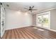 Bright bedroom featuring wood-look floors, white shiplap wall, and sliding doors to the backyard at 422 Ravenswood Blvd, Port Charlotte, FL 33954