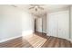 Bright bedroom featuring wood-look floors and double-door closet for ample storage at 422 Ravenswood Blvd, Port Charlotte, FL 33954