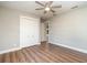Bedroom featuring wood-look floors, gray walls, a ceiling fan, and closet at 422 Ravenswood Blvd, Port Charlotte, FL 33954