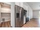 Modern kitchen with stainless steel appliances, white cabinets, and a stylish backsplash, next to a laundry area at 422 Ravenswood Blvd, Port Charlotte, FL 33954