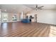 Spacious open concept living and kitchen space with lots of natural light from large windows, with sleek ceiling fan at 422 Ravenswood Blvd, Port Charlotte, FL 33954