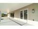 Covered, screened lanai that leads to the house via sliding glass doors, and the outside by way of a solid door at 422 Ravenswood Blvd, Port Charlotte, FL 33954
