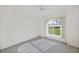 Bright bedroom with large window offering backyard views, and a ceiling fan at 43 Pinehurst Pl, Rotonda West, FL 33947