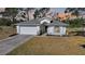 Charming single-story home featuring a two-car garage, well-manicured lawn, and tasteful landscaping at 43 Pinehurst Pl, Rotonda West, FL 33947