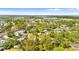 Real estate aerial showcasing neighborhood greenery, homes, and city waterscapes, offering a serene residential view at 4645 80Th N St, St Petersburg, FL 33709