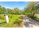 Distant view of home down long drive featuring front yard, mature trees and a mailbox at 4645 80Th N St, St Petersburg, FL 33709