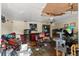Interior shot revealing a living room with damage, debris, and dated finishes at 4645 80Th N St, St Petersburg, FL 33709