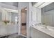 Bright bathroom featuring dual vanities, each with a separate mirror, and a glass enclosed shower at 5036 San Rocco Ct, Punta Gorda, FL 33950