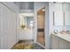 Bright bathroom featuring dual vanities, each with a separate mirror, and a glass enclosed shower at 5036 San Rocco Ct, Punta Gorda, FL 33950