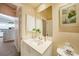 Well-lit bathroom with a granite-topped vanity and mirror at 5036 San Rocco Ct, Punta Gorda, FL 33950