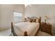 Comfortable bedroom featuring a wrought iron bed frame and neutral color scheme at 5036 San Rocco Ct, Punta Gorda, FL 33950