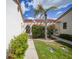 Inviting entrance with lush landscaping, pergola, and charming walkway at 5036 San Rocco Ct, Punta Gorda, FL 33950