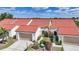 Charming townhomes featuring red tile roofs, inviting walkways, and attached garages at 5036 San Rocco Ct, Punta Gorda, FL 33950