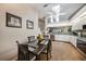 Kitchen featuring light wood floors, white cabinets, and a dining table for casual meals at 5036 San Rocco Ct, Punta Gorda, FL 33950