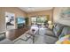 Cozy living room with hardwood floors and comfortable seating, which has easy access to the outside patio at 5036 San Rocco Ct, Punta Gorda, FL 33950
