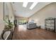 Bright living room with vaulted ceilings, a sliding glass door out to the enclosed lanai, and wood flooring at 5036 San Rocco Ct, Punta Gorda, FL 33950