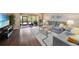 Comfortable living room featuring hardwood floors, neutral paint, view to patio, and comfortable seating at 5036 San Rocco Ct, Punta Gorda, FL 33950