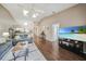Open living room with hardwood floors, vaulted ceilings, and a view into the kitchen and to the outside patio at 5036 San Rocco Ct, Punta Gorda, FL 33950