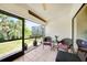 Inviting screened patio with tile flooring and comfortable seating area, overlooking the lush landscaped backyard at 5036 San Rocco Ct, Punta Gorda, FL 33950