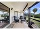 Relaxing screened patio with tile flooring and a comfortable seating area, overlooking a tropical landscaped yard at 5036 San Rocco Ct, Punta Gorda, FL 33950