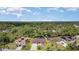 Aerial view of the property highlighting its location within a lush, wooded neighborhood at 5125 Ariton Rd, North Port, FL 34288