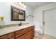 Bathroom with a sink with a granite counter, a wood cabinet, and a tile floor at 5125 Ariton Rd, North Port, FL 34288